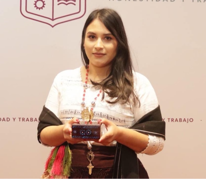 Sandra holding an award