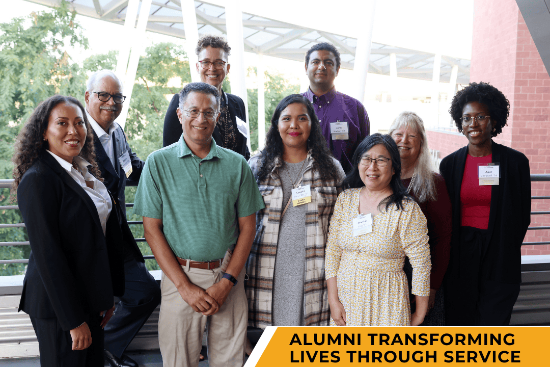 9 alumni posing and smiling