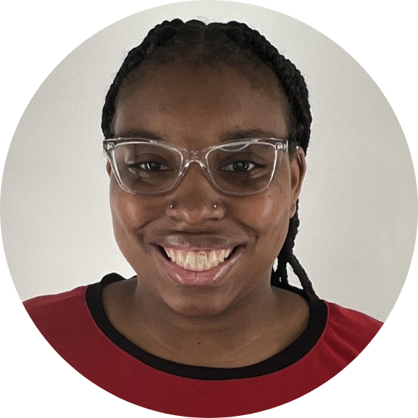 A woman with a red shirt smiling at the camera. The background is white.