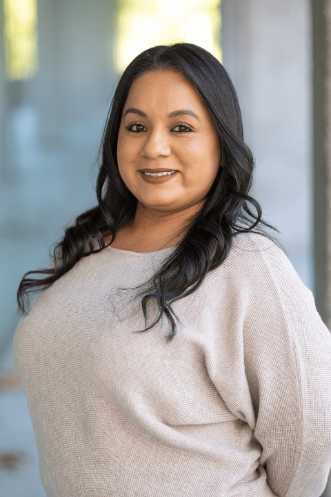 A person with long hair, smiling