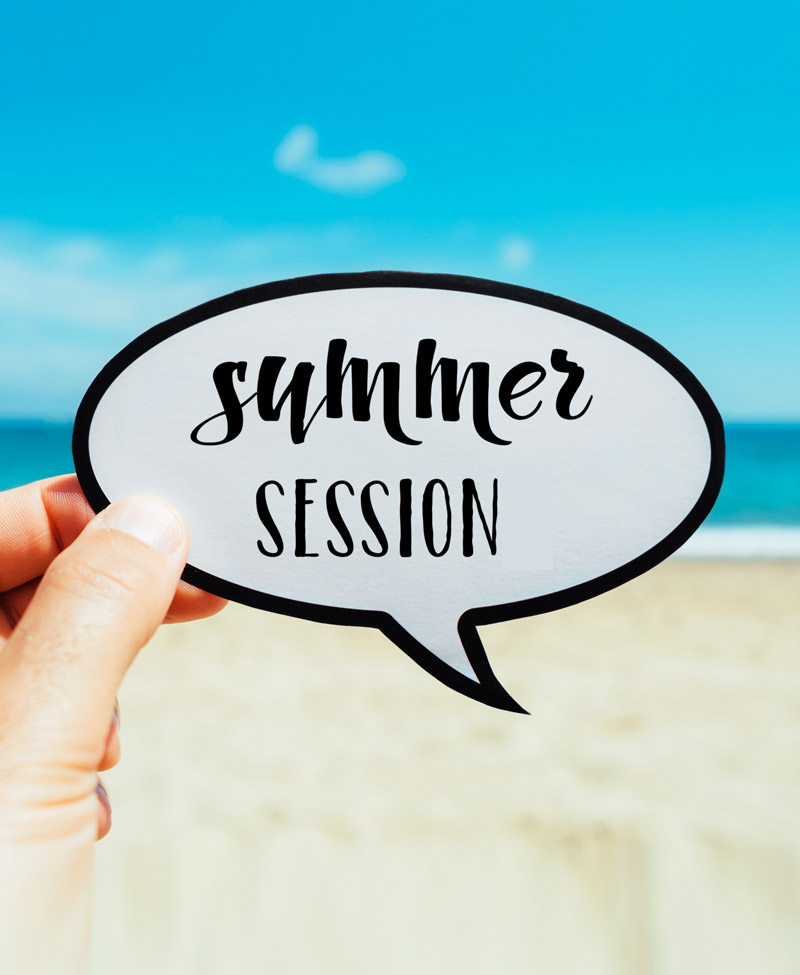 A person holding a note that says "Summer Session".