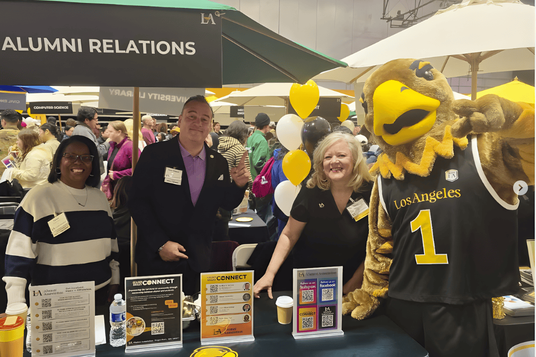 three alumni posing with Eddie the Golden Eagle mascot