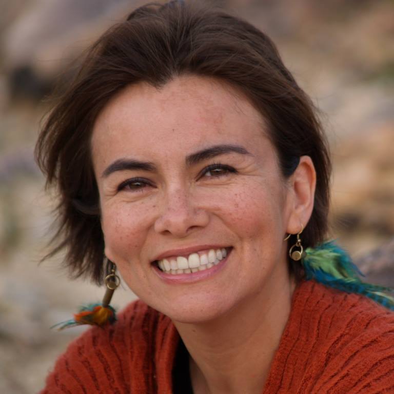 Olga smiling wearing an orange shirt