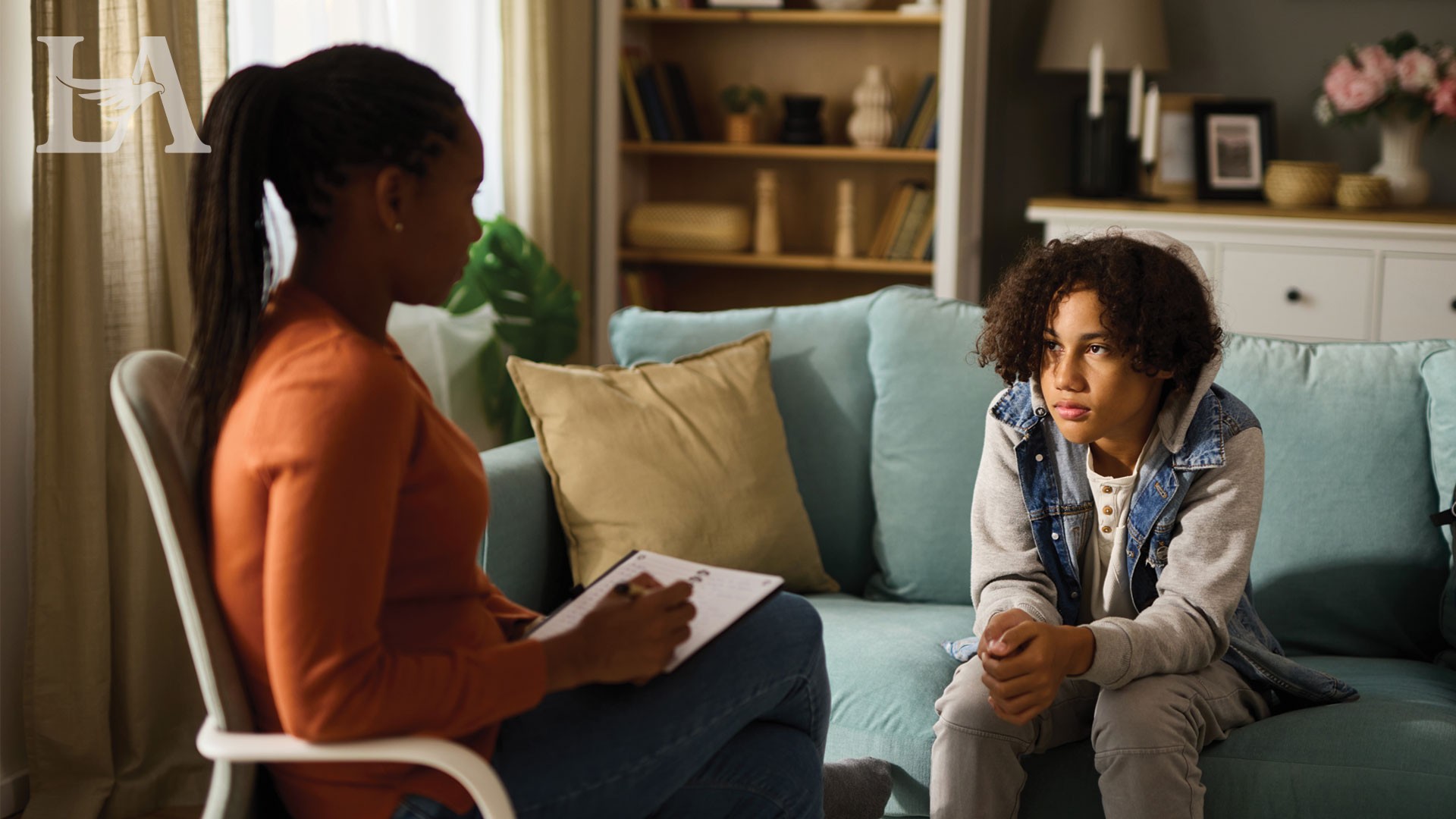A counselor and a young patient talking to each other.