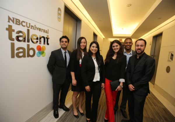 Group of people standing next to sign that says NBC Universal Talent Lab