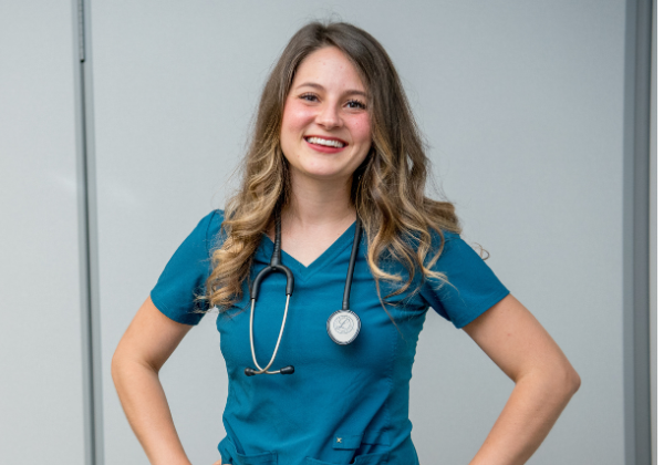 ABSN Alumna Melody Henderson wears scrubs and stethoscope.