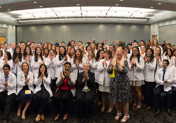 Group of people in white coats