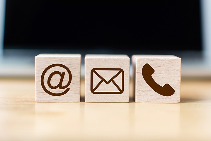 Small wood blocks with icons for email and phone.