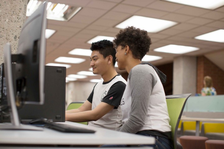 Two Students Sitting by the Computers