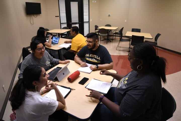 Group of students talking and sitting together