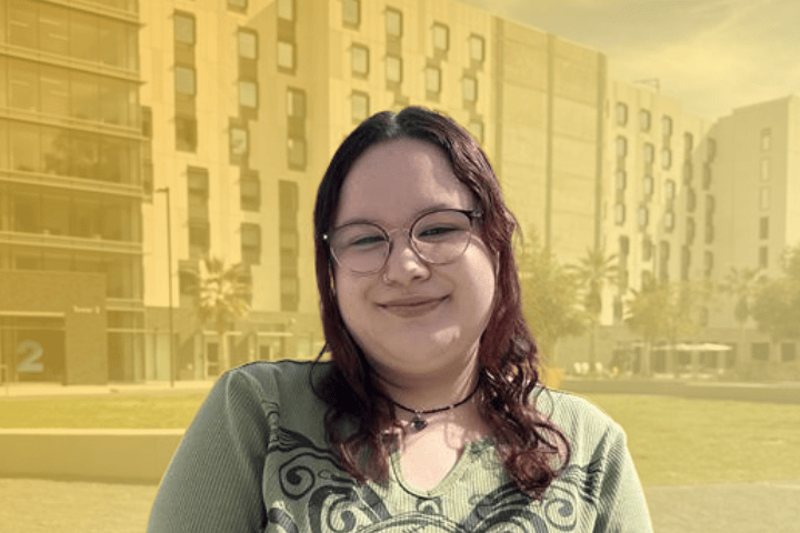 Cal State LA resident smiling in front of South Village.