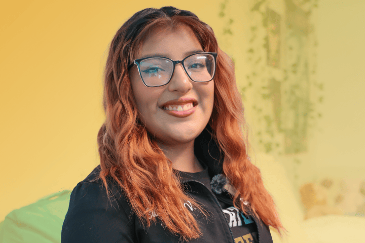 Cal State LA resident smiling in their South Village room.