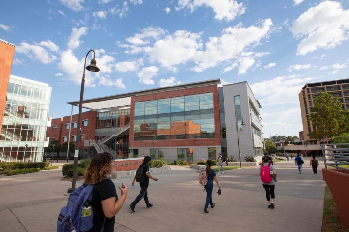 Students walking down the walkway on campus.