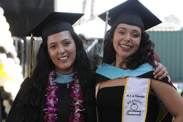 Two female graduates at commencement