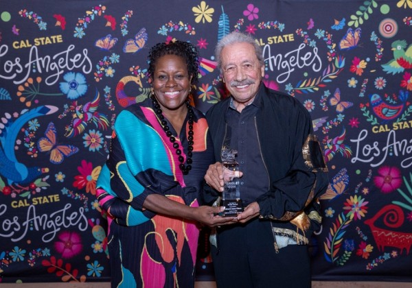 Actor-director-producer Edward James Olmos accepts the Prism Award from Cal State LA President Berenecea Johnson Eanes on Friday, Oct. 10, 2025. The award is given to creators for their outstanding contributions to diversity in speculative media.