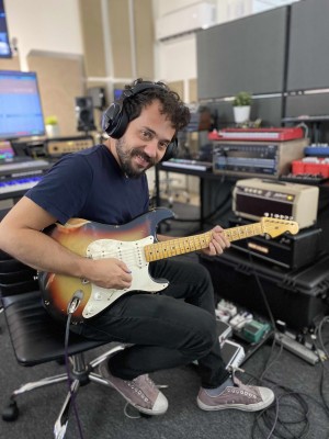 JP recording with a strat-style guitar in a home studio