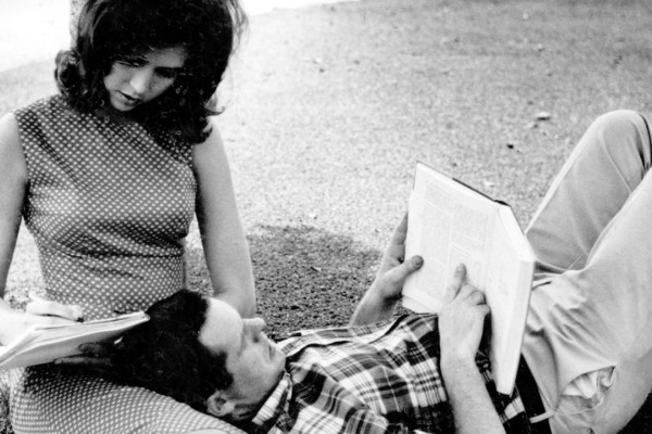 A couple studying on a lawn