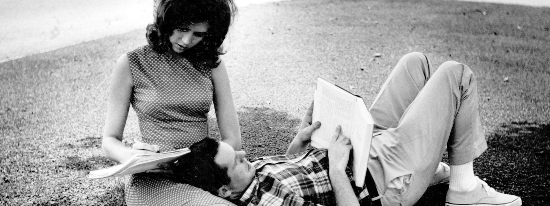 A couple studying on a lawn