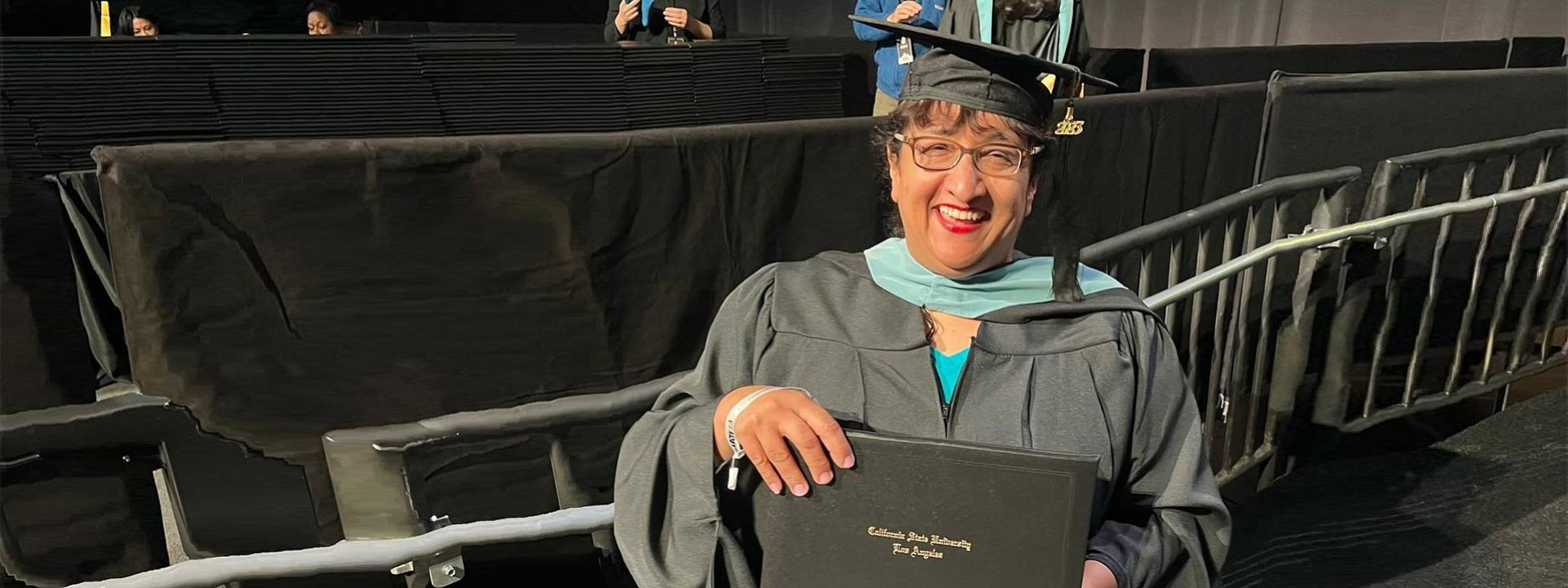 female graduate holding diploma