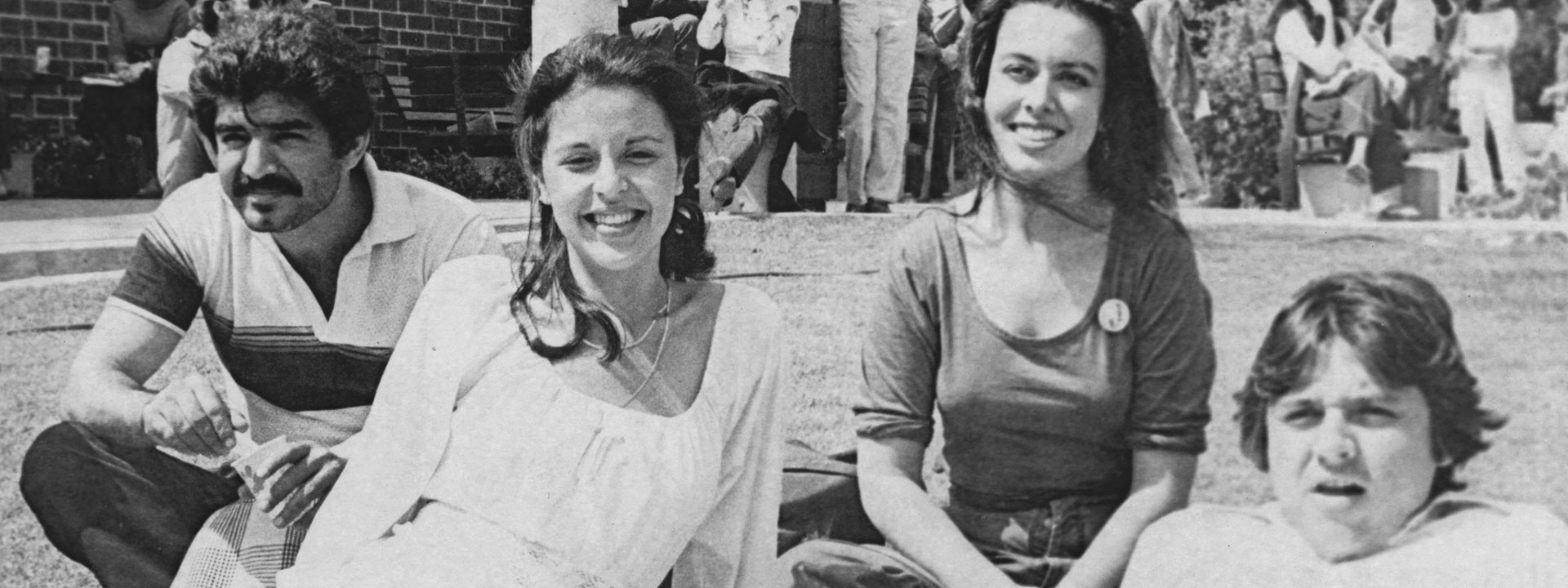 A group of students on a campus lawn